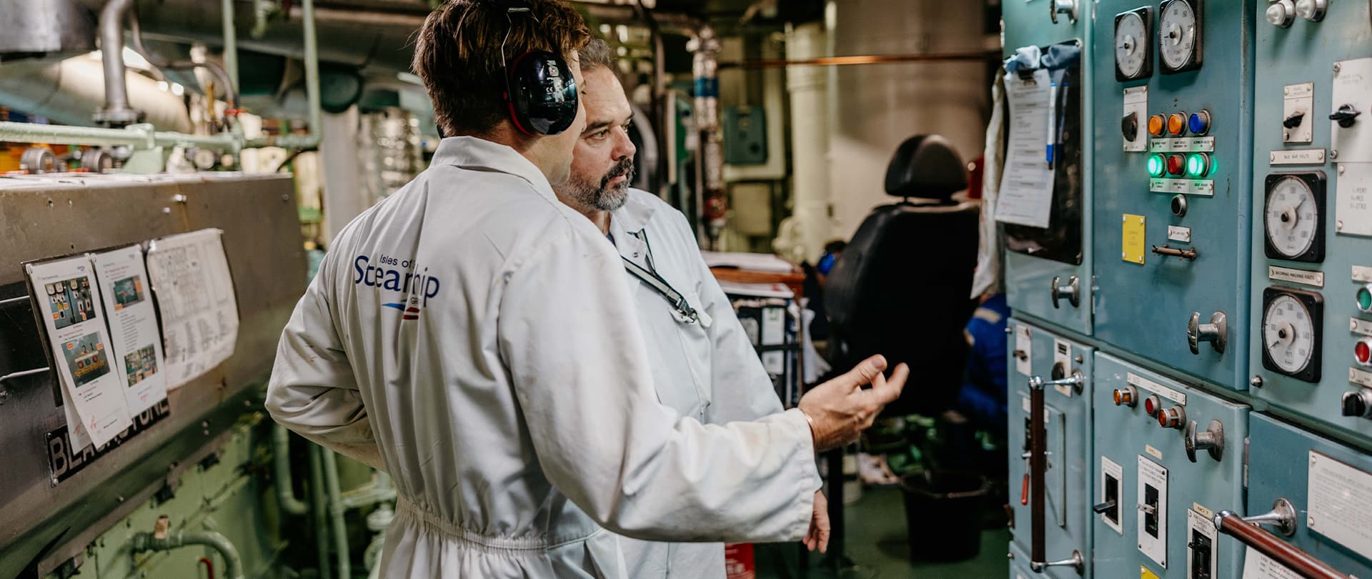 two marine engineers carrying out maintenance checks in the engine room on Scillonian III