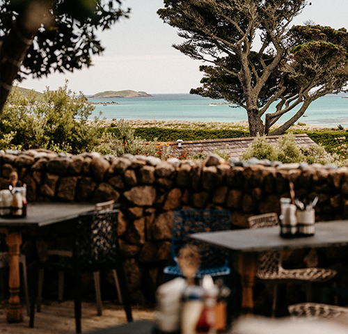 Outdoor seating area for Seven Stones Inn, views towards par beach, St martins