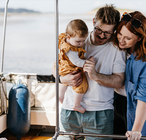 Family looking at the glass bottom on the boat seaquest, Isles of Scilly