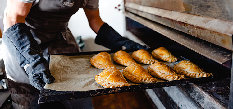 The Island Bakery Cornish pasties being pulled out of the oven - St Martin's, Isles of Scilly