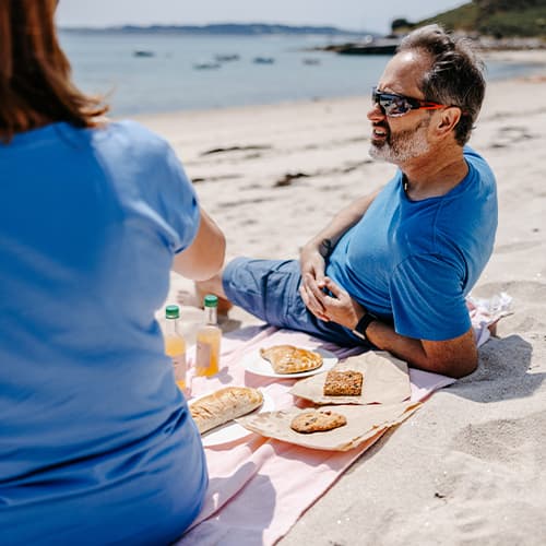 couple having a picnic on par beach, st martin's